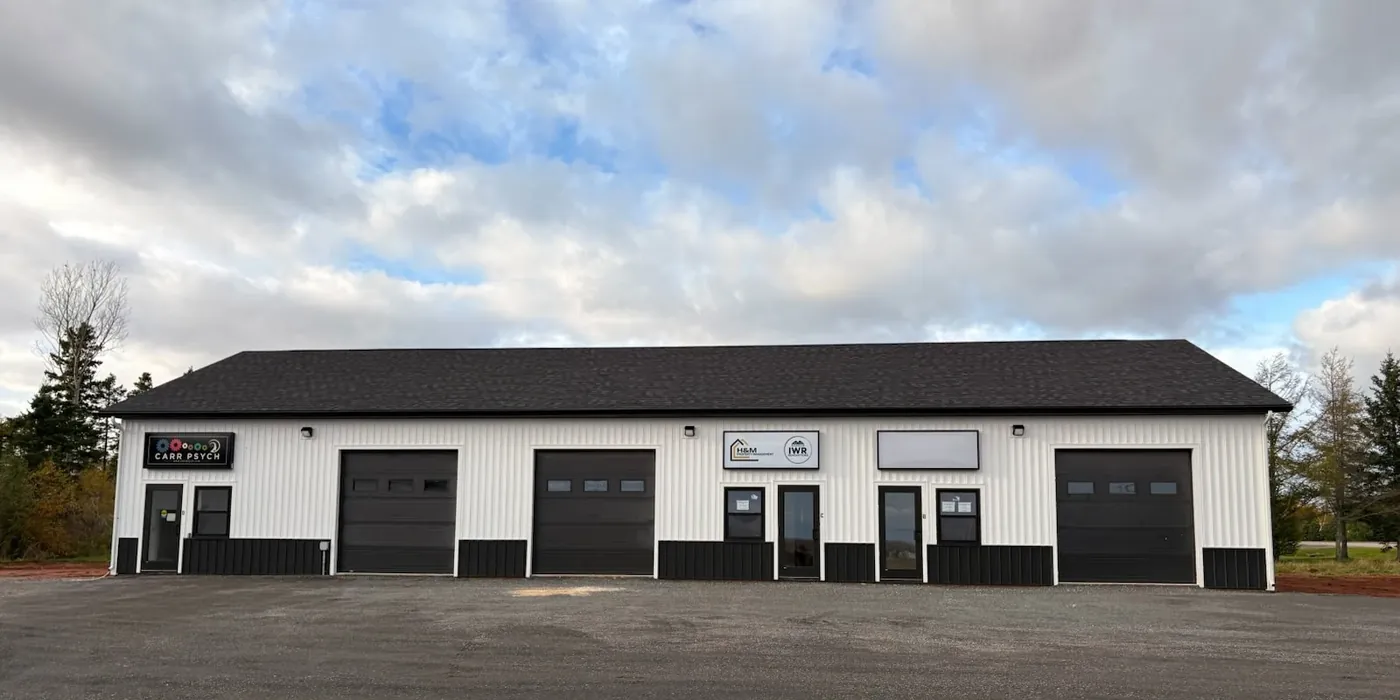 Front of Pooles Corner Plaza with its bay doors and tenant signs